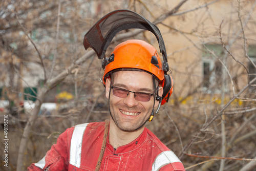 Tree surgeon. Working with a chainsaw. Sawing wood with a chainsaw.