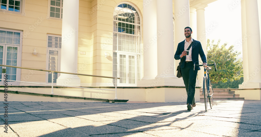 Someone is in a happy mood this morning. Full length shot of a young businessman commuting to work with his bicycle. Someone is in a happy mood this morning. Full length shot of a young businessman commuting to work with his bicycle.