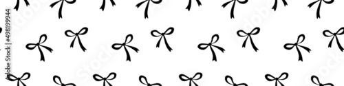 Seamless pattern with small black flat bows, ribbons. Cute fun simple abstract vector background, texture for fabric, wrapping paper, girls design