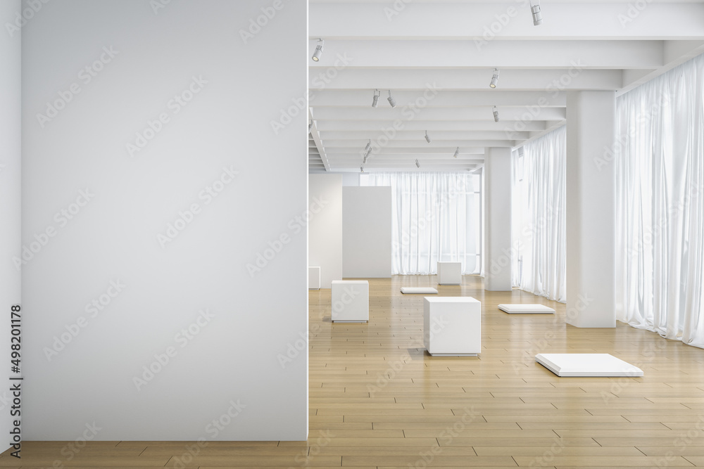 Light blank wall in the foreground with copyspace for your text in empty modern light exhibition hall with white details and stands on natural color wooden floor. 3D rendering, mockup