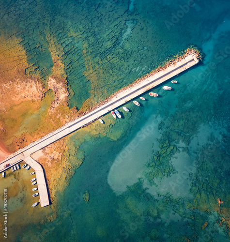 Straight down view from flying drone of pier in Kardamyli port. Colorful morning seascape of Ionian sea. Bright outdoor scene of Peloponnese peninsula, Greece. Traveling concept background.