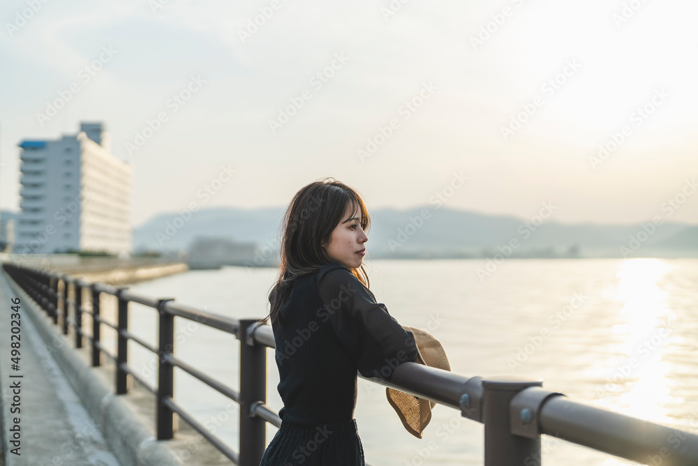 夕暮れの海で黄昏れる女性 夕暮れの海で黄昏れる女性