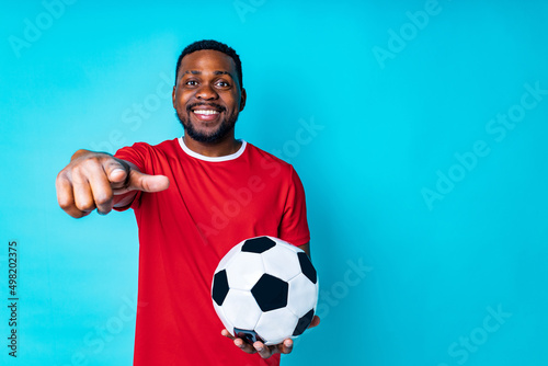 happiness brazilian player man over isolated blue background