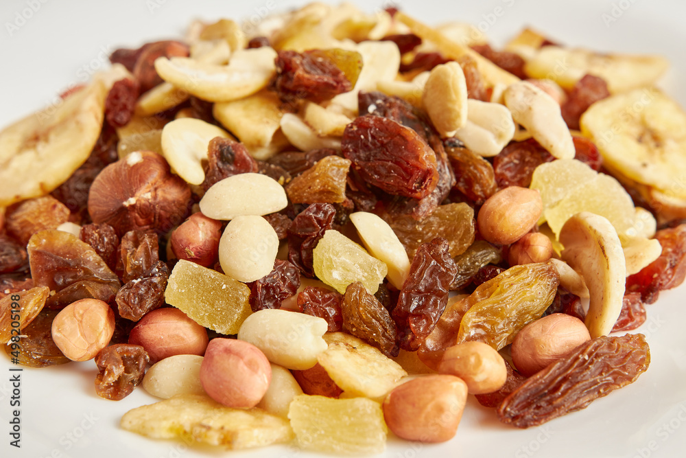 Assorted fruits and nuts. Dried healthy food. Dried grapes, peanuts, pineapple, banana, cashews, almonds. Assorted fruits and nuts. Dried healthy food. Dried grapes, peanuts, pineapple, banana, cashews, almonds.
