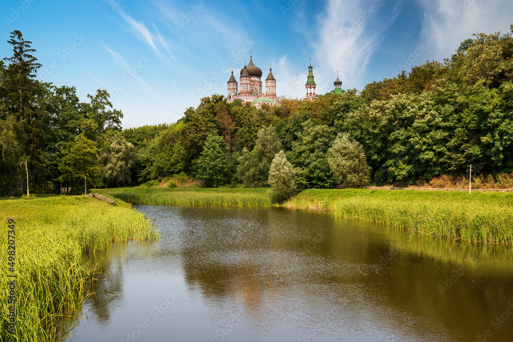 Scenic view of pond in Feofaniya park in Kyiv, Ukraine. St. Panteleimon Convent mirrored in the water