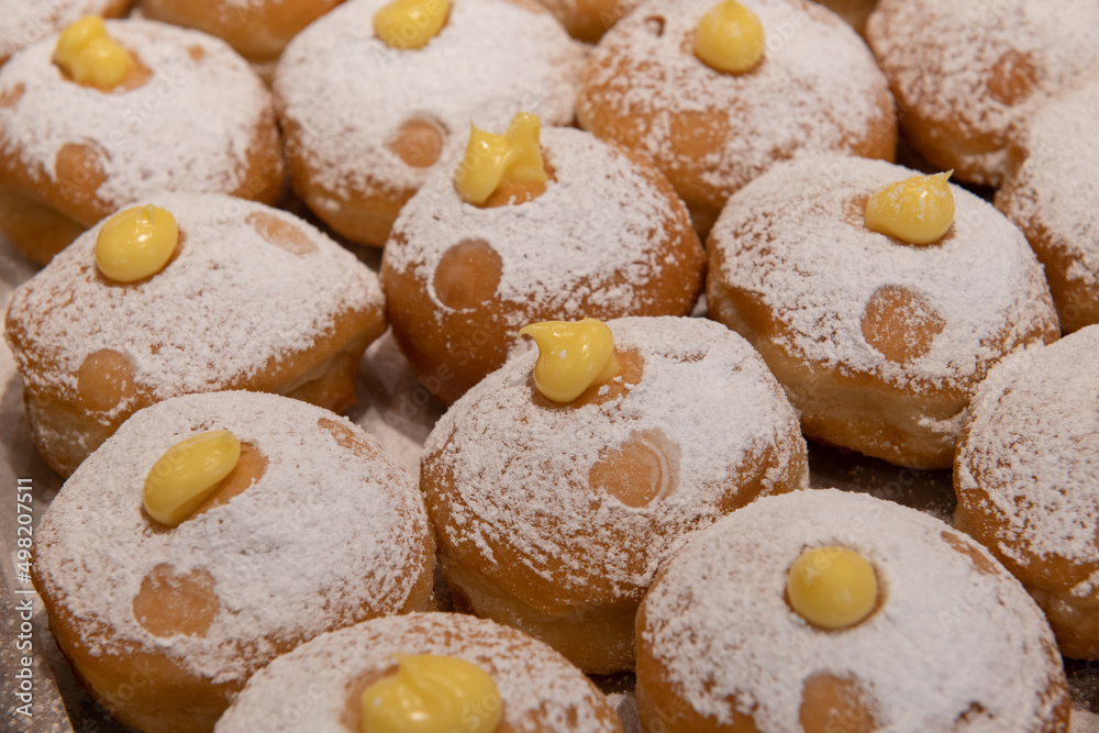 Decorative vanilla cream-filled donuts on sale at a bakery in Israel.