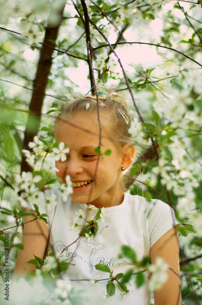 Little girl laughing in the cherry orchard