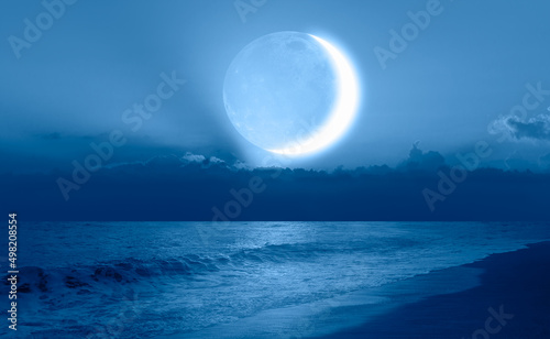 Abstract background with Crescent moon over the sea at sunset