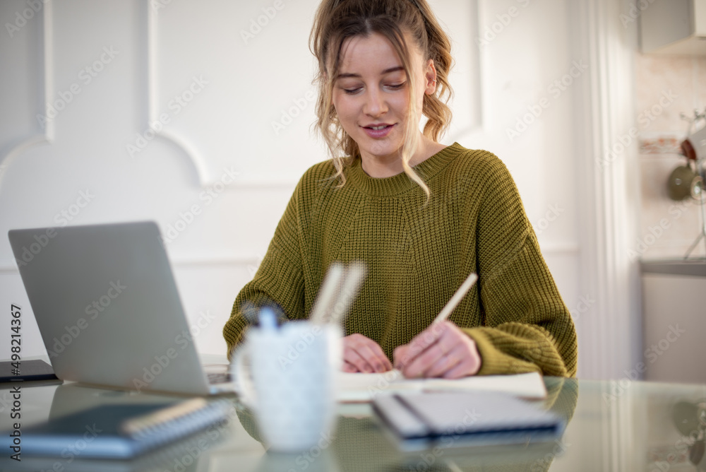 Woman working from a home on her a laptop Woman working from a home on her a laptop
