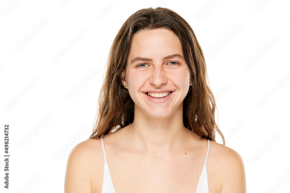 Portrait of a young smiling woman without makeup on a white background Portrait of a young smiling woman without makeup on a white background