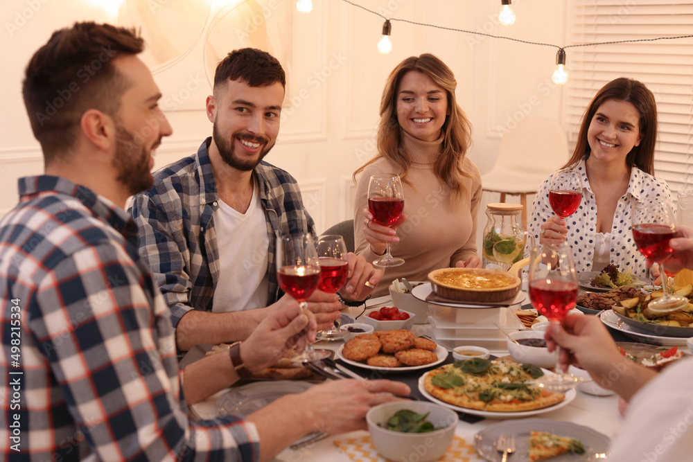Group of people having brunch together at table indoors Group of people having brunch together at table indoors