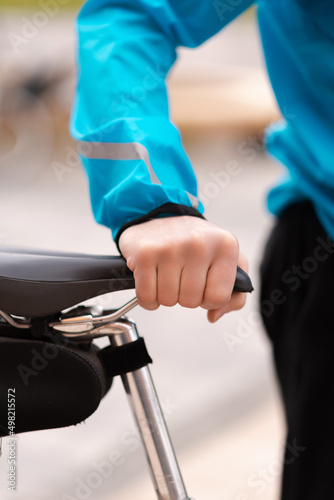 Man holding his bicycle seat. Cropped Image