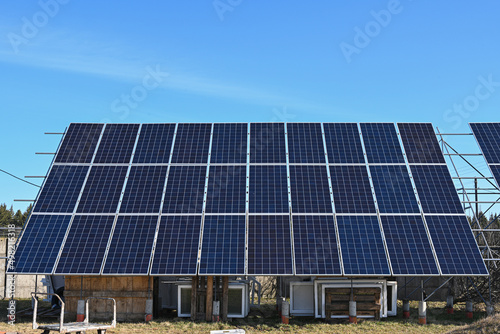 High resolution front view photo of solar panels against a clear blue sky