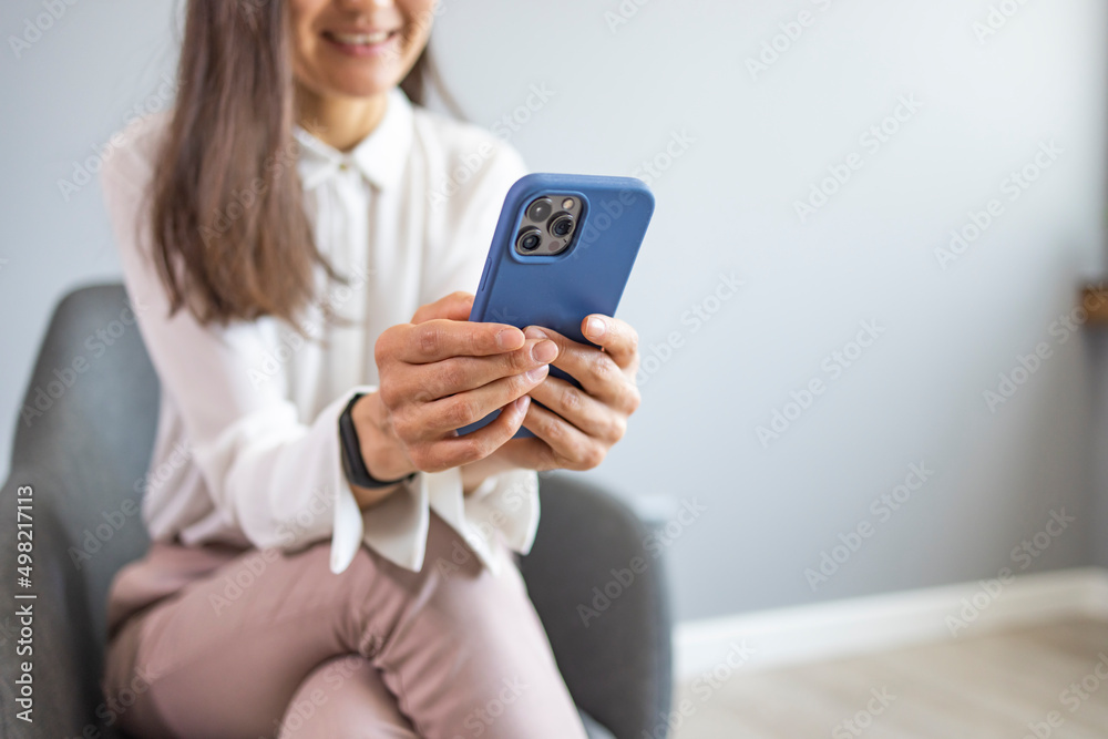 Cose up young asian woman looking at smartphone for video online chat with friends or surf the internet or playing mobile application in relax time, millennial technology lifestyle concept Cose up young asian woman looking at smartphone for video online chat with friends or surf the internet or playing mobile application in relax time, millennial technology lifestyle concept