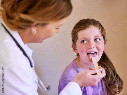 Now say aaah. Shot of a pediatrician examining a little girl in her office.