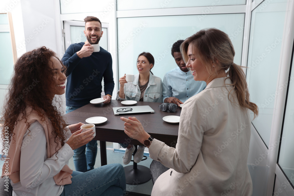 Fototapeta premium Team of employees enjoying coffee break together in office. Startup project