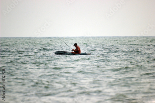 fisherman catches fish in the Black sea on a boat 