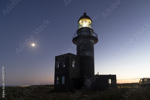 Working lighthouse and starry sky