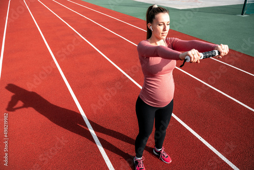 Pregnancy health. Prenatal healthy fitness active fit gym outside. Pregnant woman training yoga sport exercise. Pregnancy yoga exercise.