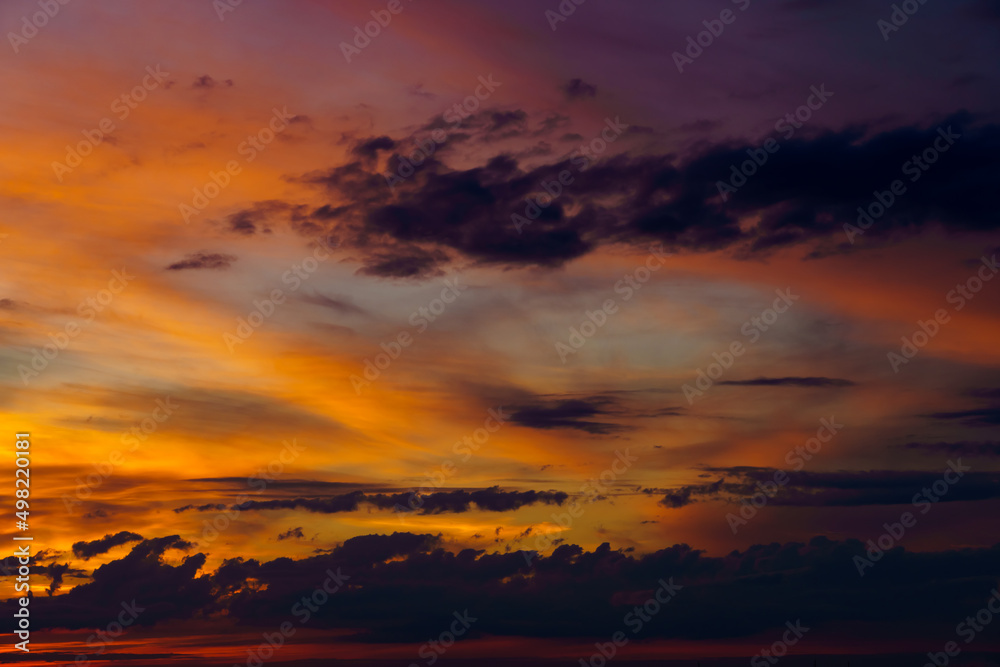 beautiful dramatic sunset sky, bright sunlight and dark silhouette of clouds as a background