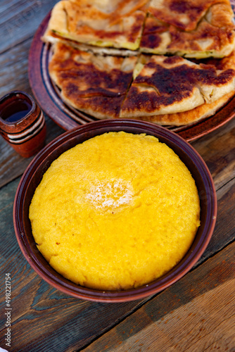 polenta is a dish made from corn flour, served with a book and cheese. Traditional food in Romania and the Republic of Moldova