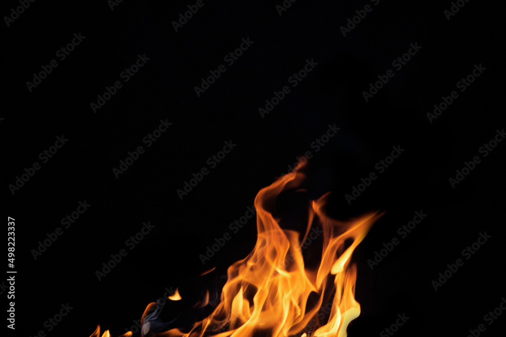 Close up burning flames on black background for graphic design or wallpaper Close up burning flames on black background for graphic design or wallpaper