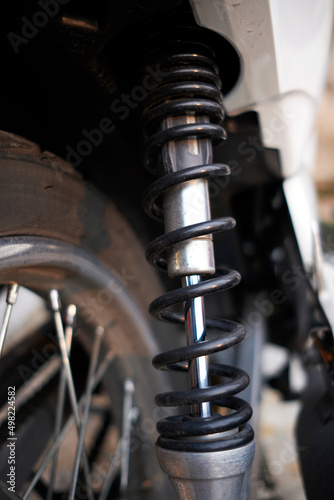 Black motorcycle suspension with shock absorber. The springy flexibility of the machine. Jumping into the air