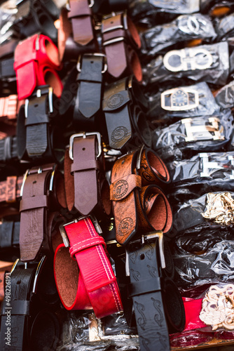 Lagos Island, Lagos NIGERIA - April 8, 2022: Various type of leather belt displayed for slae in roadside marketplace. selective focus © Tolu Owoeye