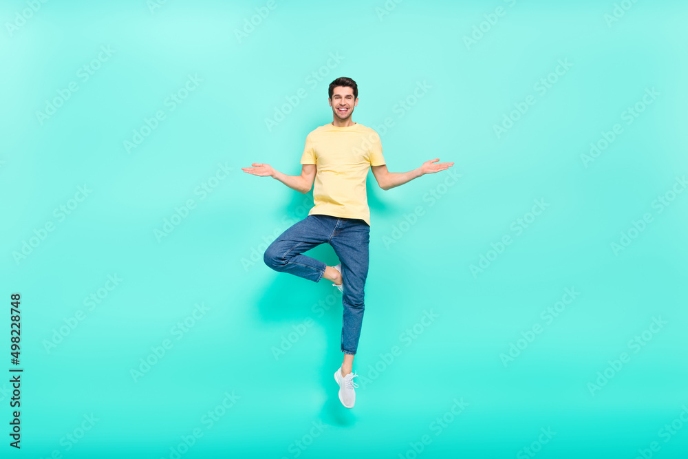 Full length portrait of satisfied glad young person hands palms isolated on teal color background Full length portrait of satisfied glad young person hands palms isolated on teal color background