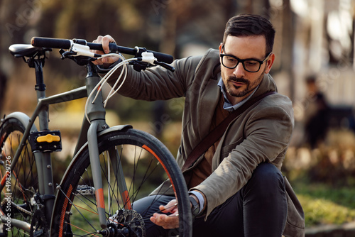 Focused man, repairing a glitch on his bike