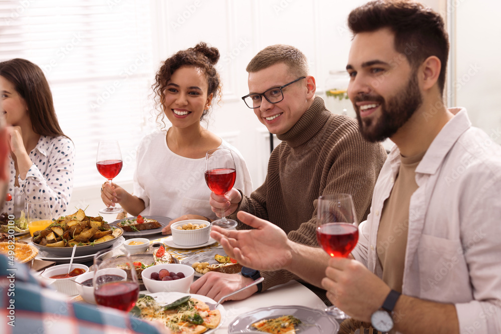 Group of people having brunch together at table indoors Group of people having brunch together at table indoors