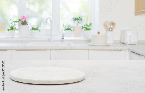 Pedestal for product on wooden table in blurred kitchen interior