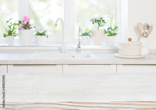 Wooden table on blurred background of kitchen blurred sink window