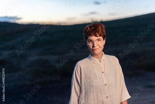 Portrait at dusk of a non-binary gender woman outside