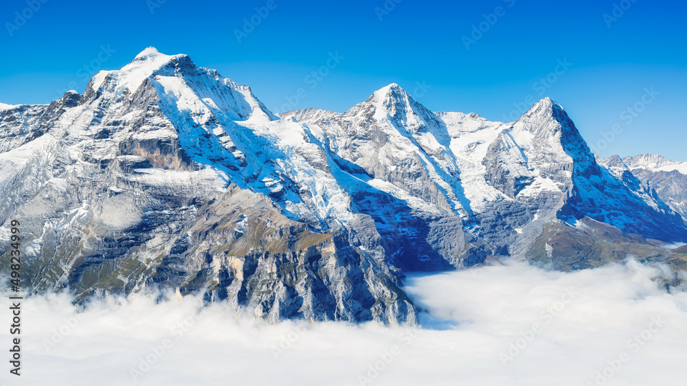 Mountain scenery in the Swiss Alps. Mountains peaks. Natural landscape. Mountain range and clear blue sky. Landscape in the summertime.