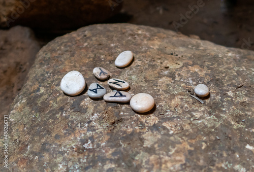 Small  pebbles with pagan runes lie on a large stone in remnants of the megalithic complex of the early Bronze Age  - Wheels of Spirits - Rujum Al-Hiri - Gilgal Rephaeem - on Golan Heights in Israel photo
