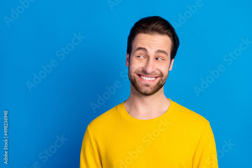 Portrait of attractive cheerful cunning bewildered brunet guy thinking copy space isolated over bright blue color background © deagreez