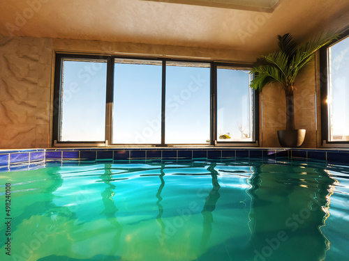 Empty indoors swimming pool with emerald green water © Bits and Splits