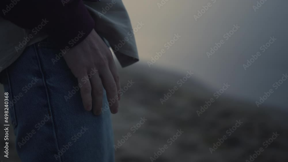 Unrecognizable man tapping fingers on legs. Guy holding hand on jeans pocket