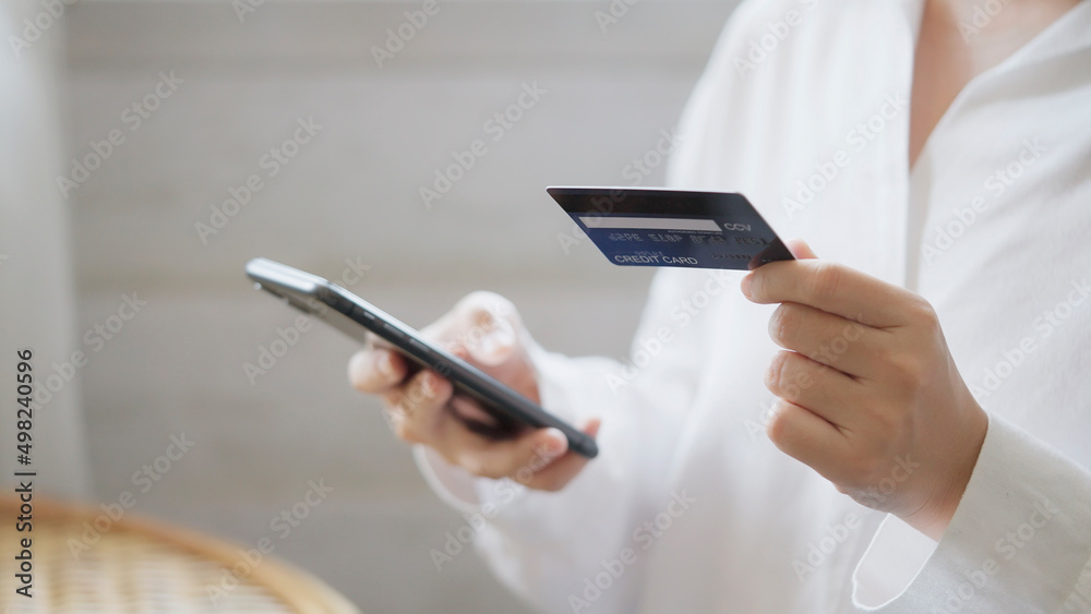 Young Asian woman shopping on mobile phone with Credit card. Young Asian woman shopping on mobile phone with Credit card.