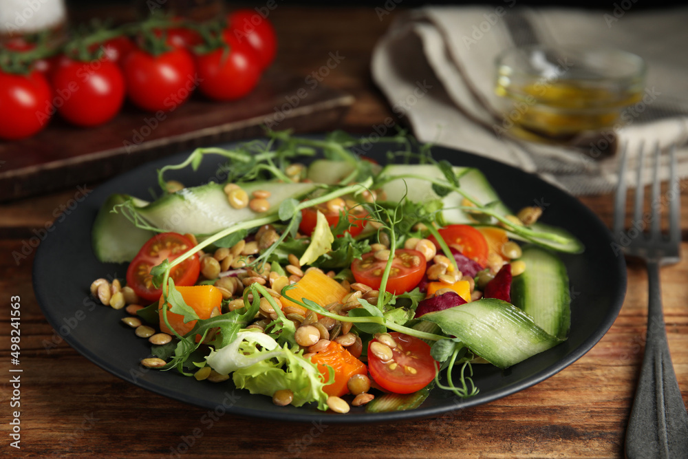 Delicious salad with lentils and vegetables on wooden table, closeup Delicious salad with lentils and vegetables on wooden table, closeup