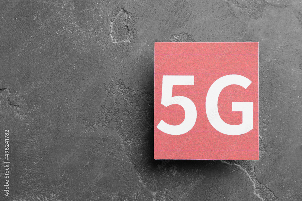 Internet concept. 5G red card on grey table, top view and space for text Internet concept. 5G red card on grey table, top view and space for text
