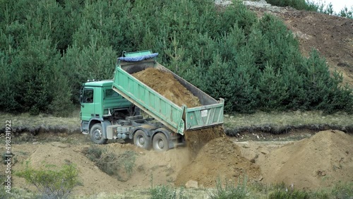 Wallpaper Mural Construction truck dumping, unloading gravel on road construction site, preparing ground for new housing estate Torontodigital.ca