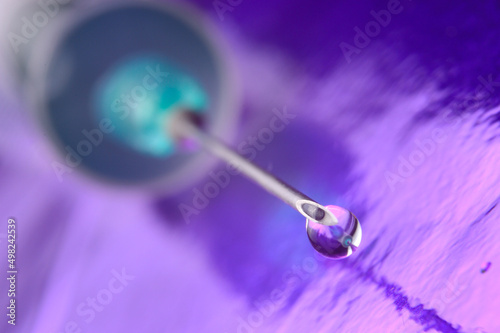 Syringe needle and a drop of a transparent substance. close-up © Oleg
