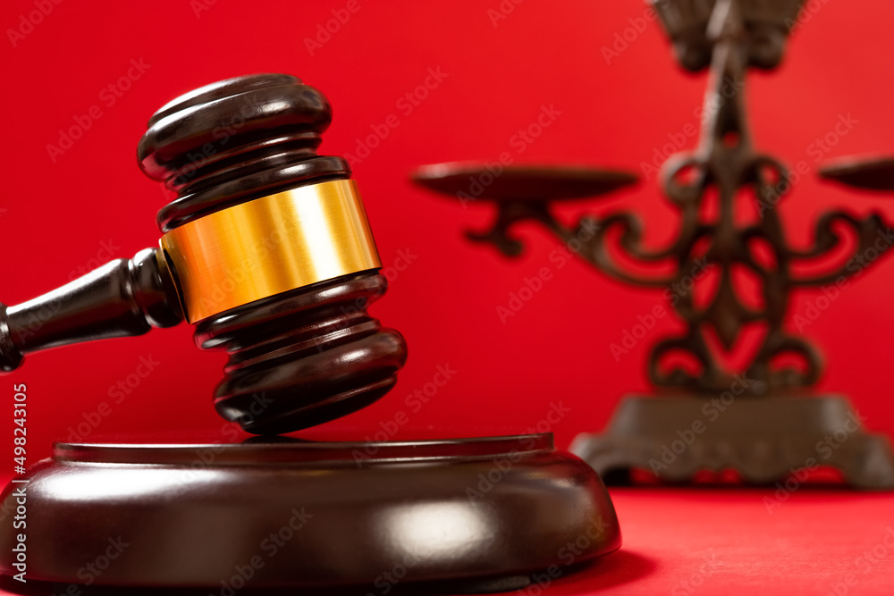 gavel on red with a scale on background