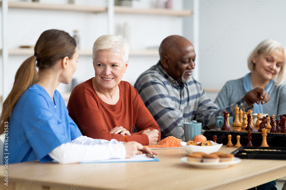 Nurse having conversation with attractive senior woman Nurse having conversation with attractive senior woman
