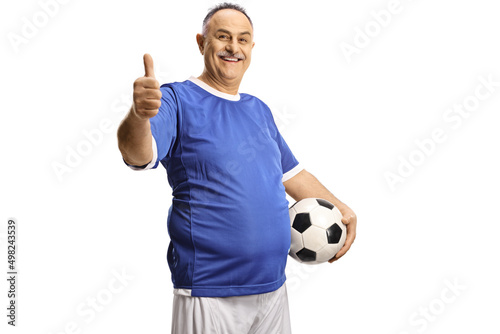Cheerful mature man in a football jersey holding a ball and gesturing thumbs up