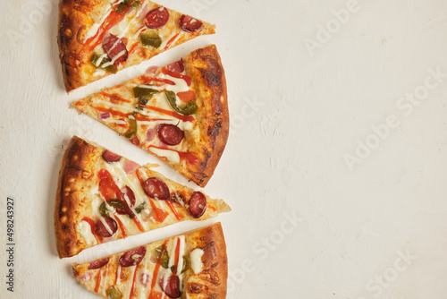slices of pizza are laid out in a row on a light background copy space top view