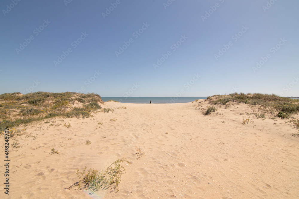 Isla Cristina beach, Huelva, Spain. A blue sky and fine sand. Concept of the best beaches. Isla Cristina beach, Huelva, Spain. A blue sky and fine sand. Concept of the best beaches.