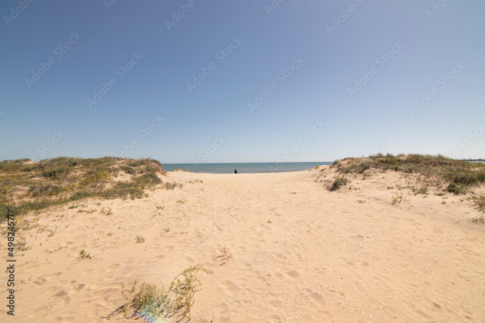 Isla Cristina beach, Huelva, Spain. A blue sky and fine sand. Concept of the best beaches. Isla Cristina beach, Huelva, Spain. A blue sky and fine sand. Concept of the best beaches.